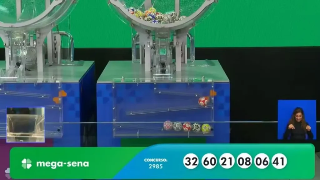 Máquinas Da Mega-Sena Durante O Sorteio Do Concurso 2985 Exibindo As Dezenas 32, 60, 21, 08, 06 E 41 Na Tela Oficial Da Caixa