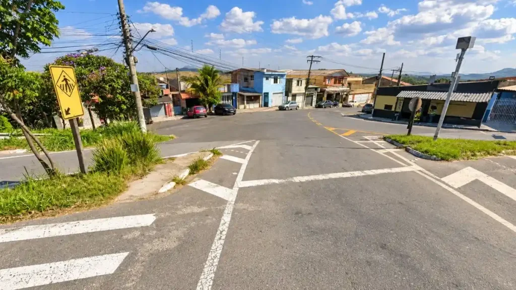 Entrada do bairro Sítio Aparecida, em Caieiras, com cruzamento viário, casas, comércios e área urbana ao redor.